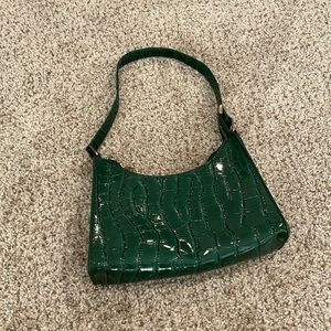 This is a dark green handbag.
